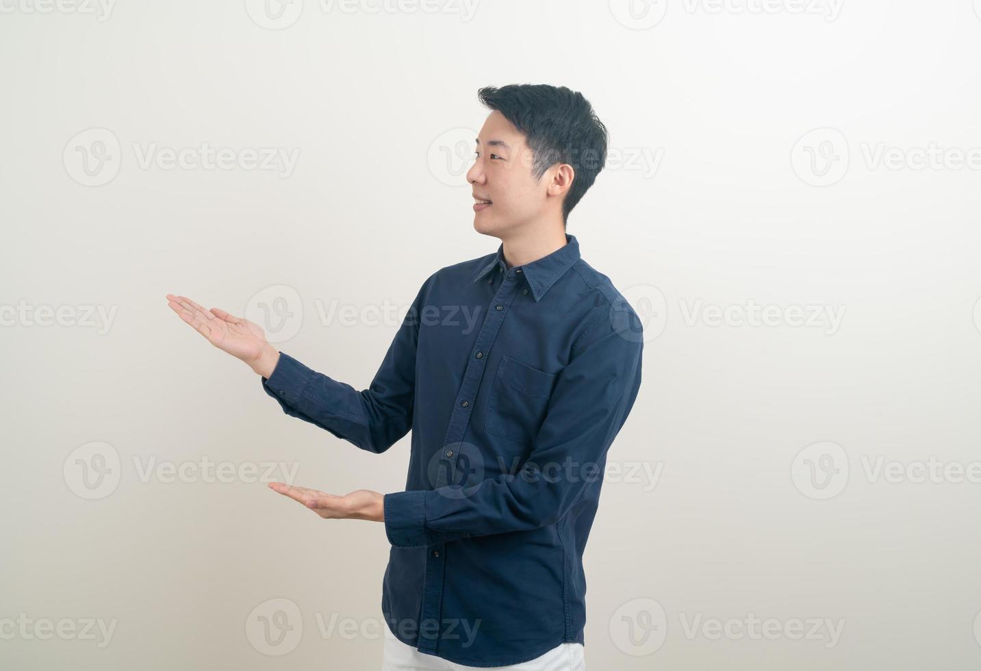 Asian man with hand pointing or presenting on white background photo