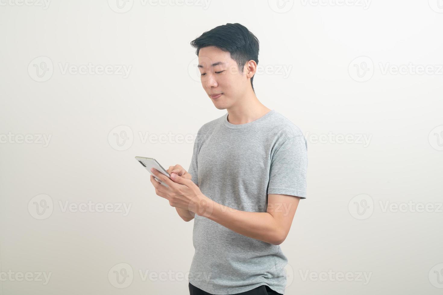 young Asian man using or talking smartphone and mobile phone photo