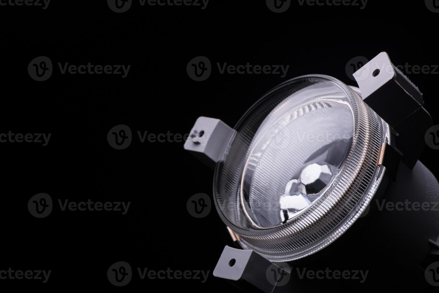 closeup round car headlights on a black background isolated photo