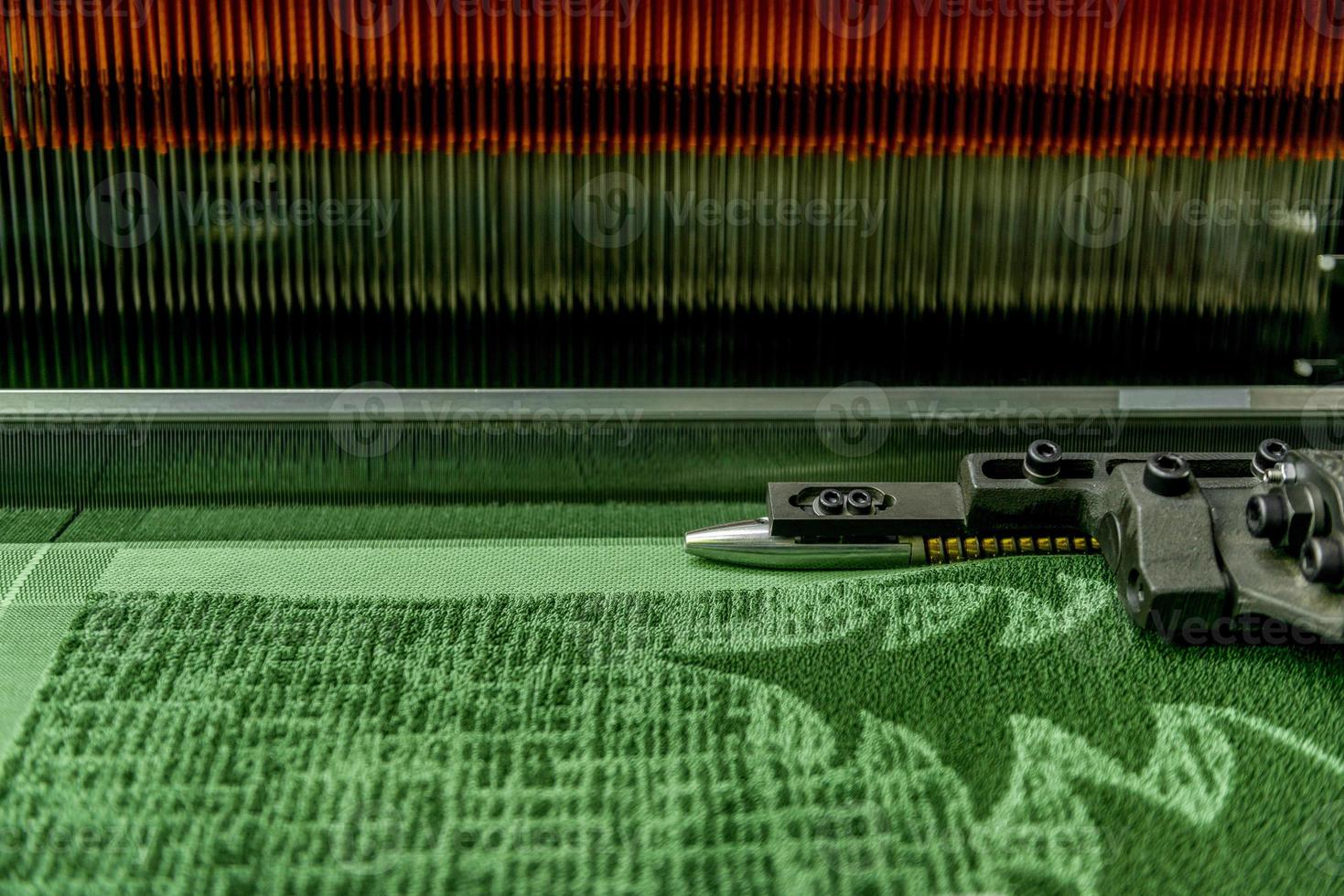weaving loom at a textile factory, closeup. industrial fabric production line photo