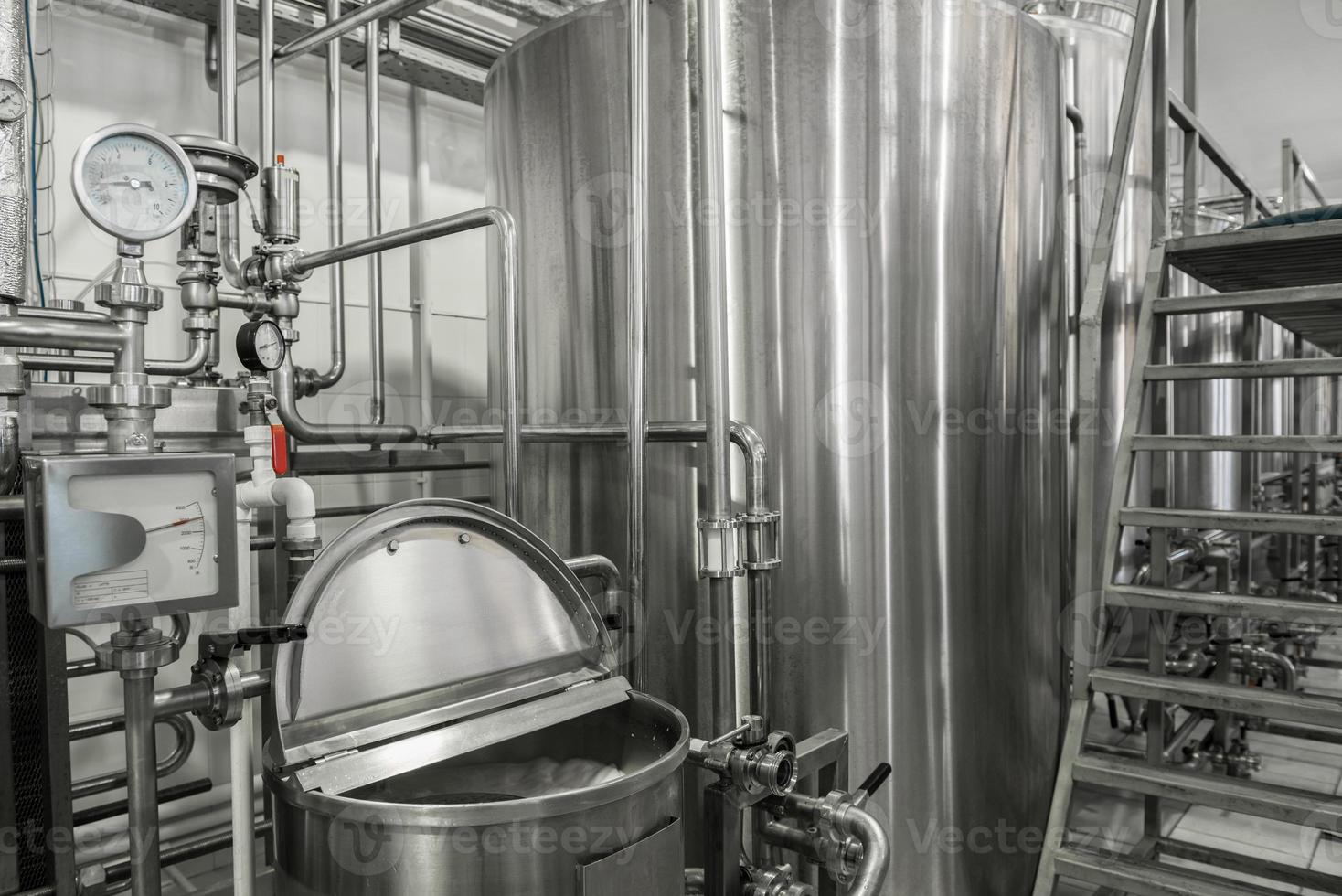 storage and pasteurization tank at the milk factory. equipment at the dairy plant photo