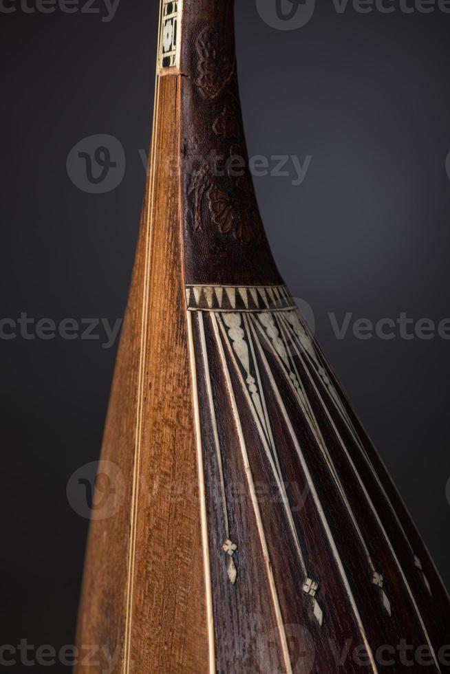 part ancient Asian stringed musical instrument on black background with backlight photo