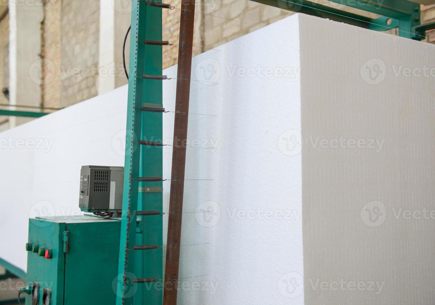 The machine cuts foam plastic. Plant for the production of sandwich panels from styrofoam photo