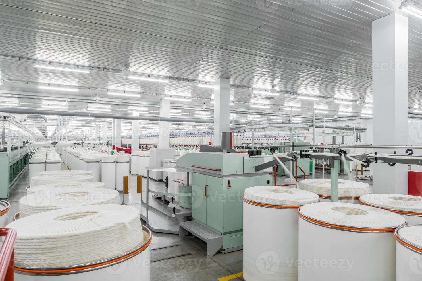 Machinery and equipment in the workshop for the production of thread. Interior of industrial textile factory photo