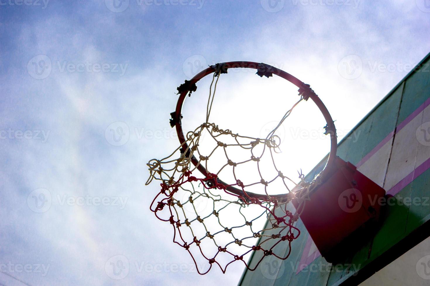 Wooden basketball hoop with blue sky background photo