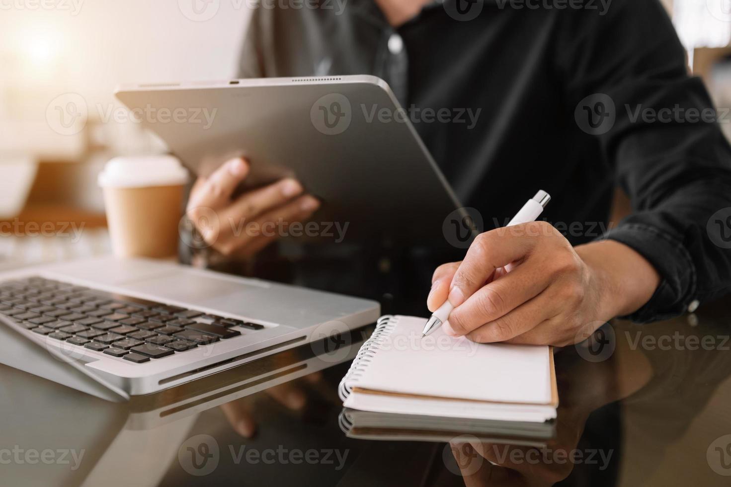 businessman hand working with new modern computer and writing on the notepad strategy diagram photo