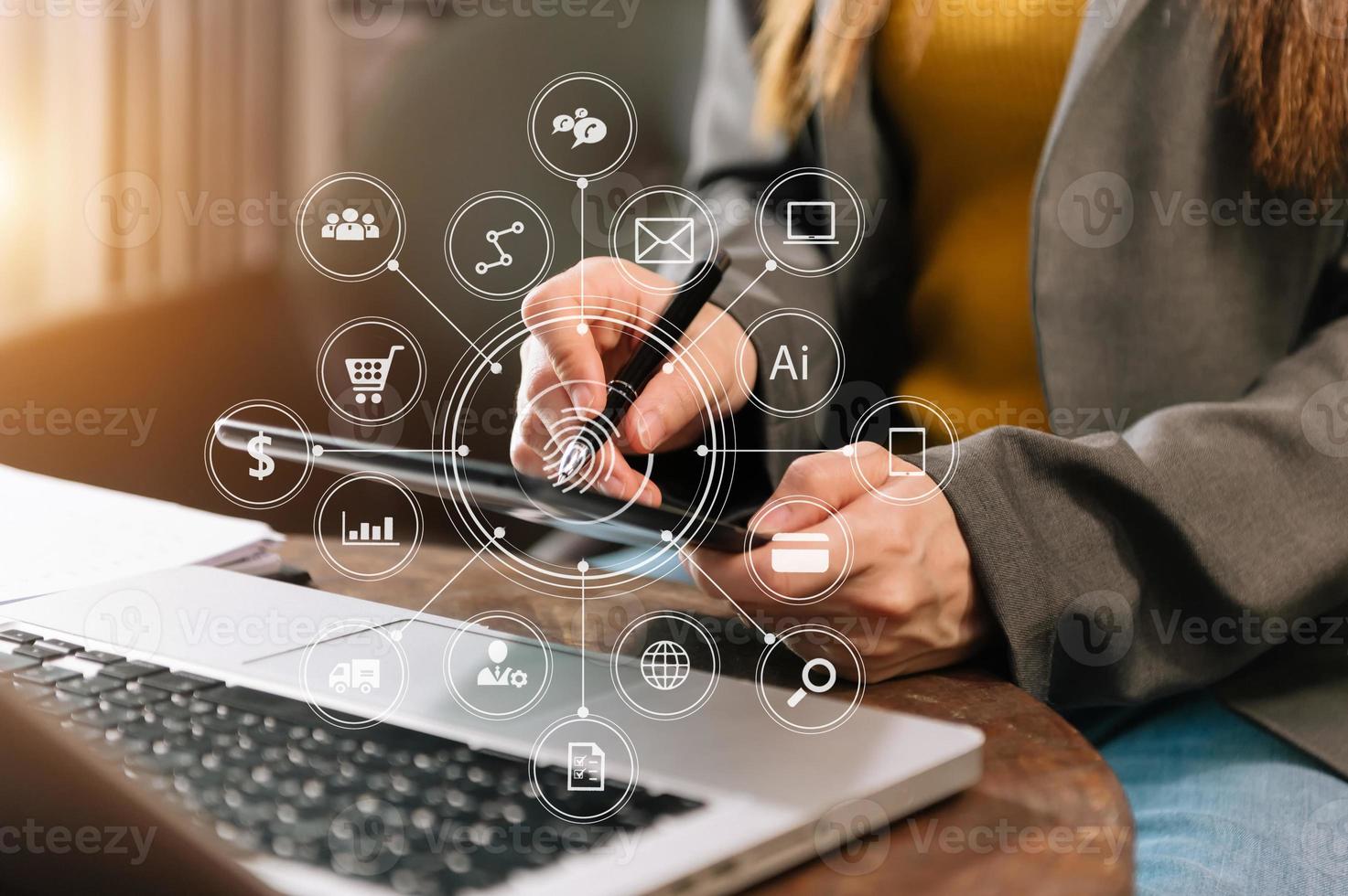 businesswoman or Designer using mobile phone with laptop and digital tablet laptop and document on desk in office with virtual icons network diagram photo