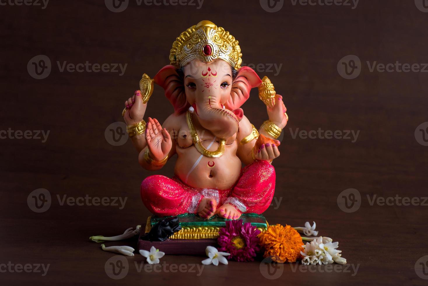 Hindu God Ganesha. Ganesha Idol on dark wooden background. 5577946 Stock  Photo at Vecteezy