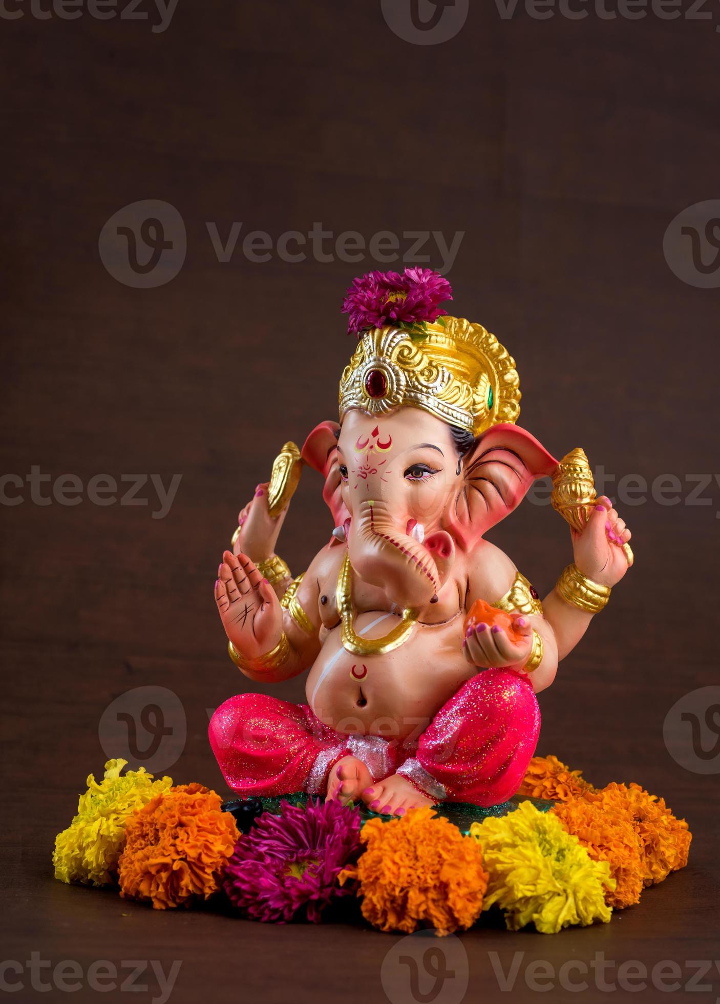 Hindu God Ganesha. Ganesha Idol on dark wooden background. 5578234 Stock  Photo at Vecteezy