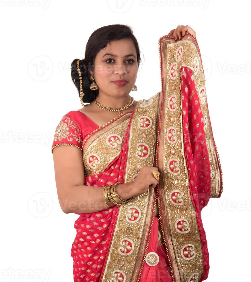 Beautiful young girl posing in Indian traditional saree on white background. photo