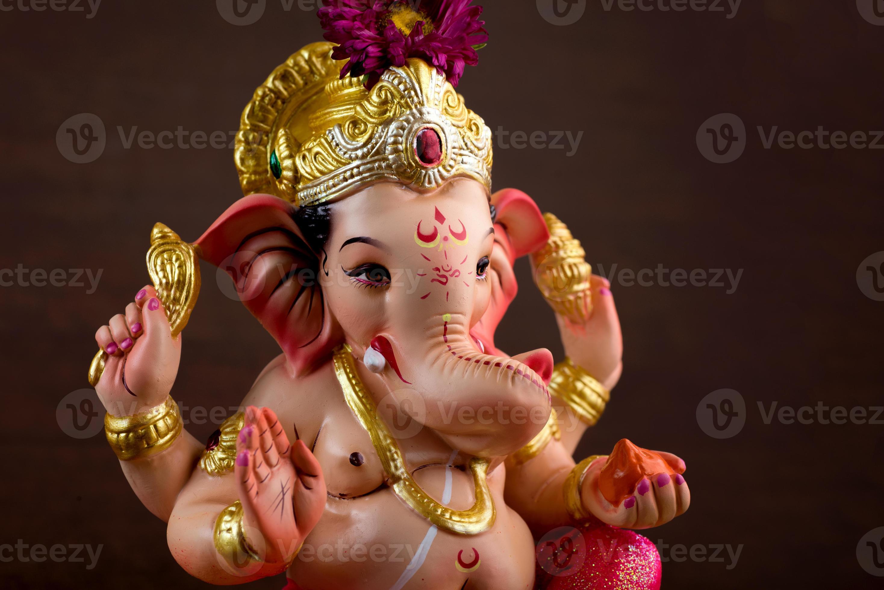 Hindu God Ganesha. Ganesha Idol on dark wooden background. 5578979 Stock  Photo at Vecteezy