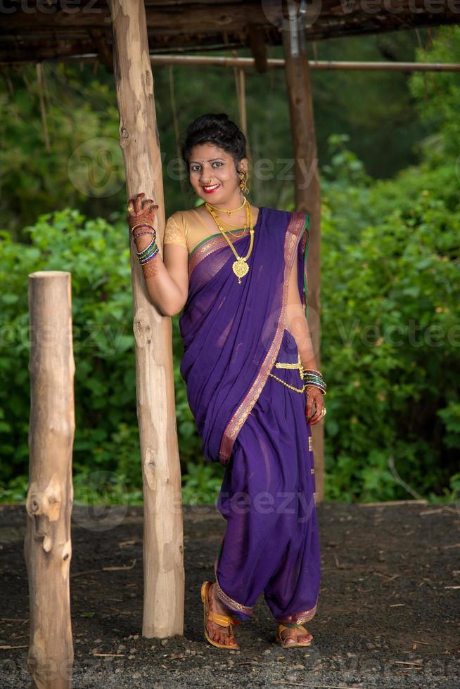 Beautiful Indian young girl in Traditional Saree posing outdoors photo