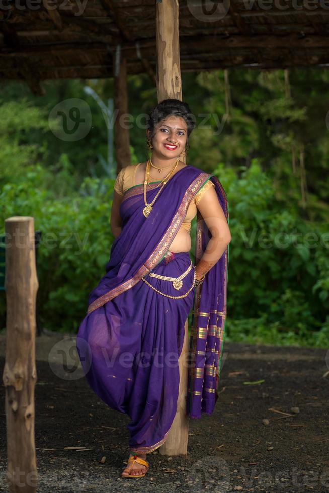 Beautiful Indian young girl in Traditional Saree posing outdoors photo