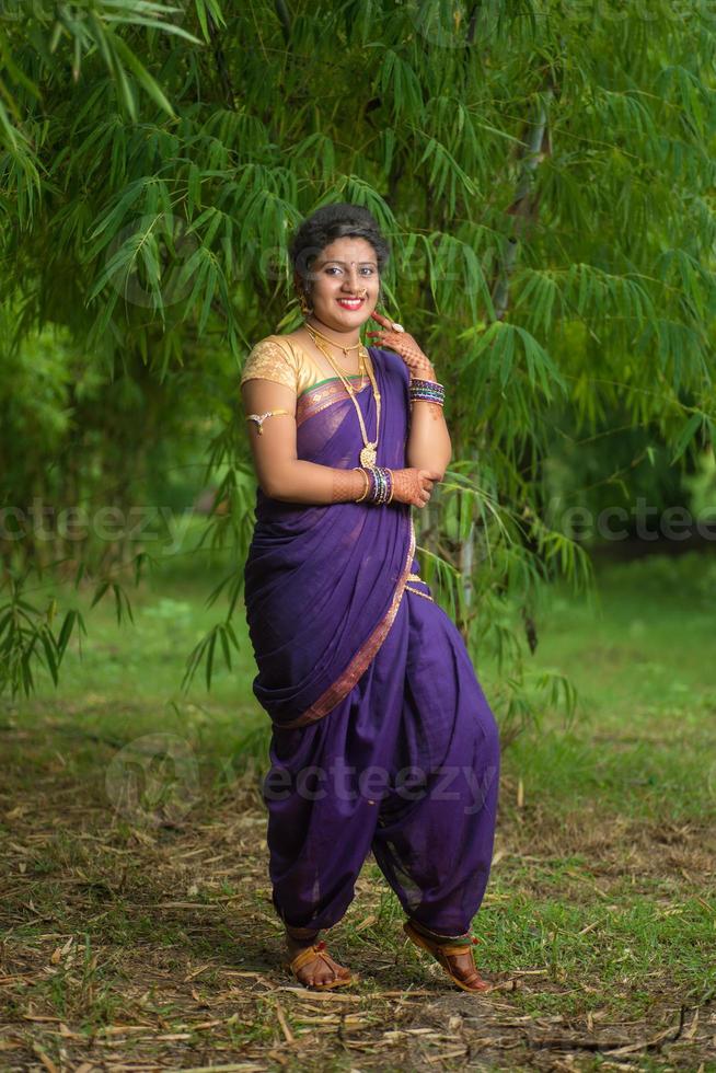 Indian Beautiful young girl in Traditional Saree posing outdoors photo