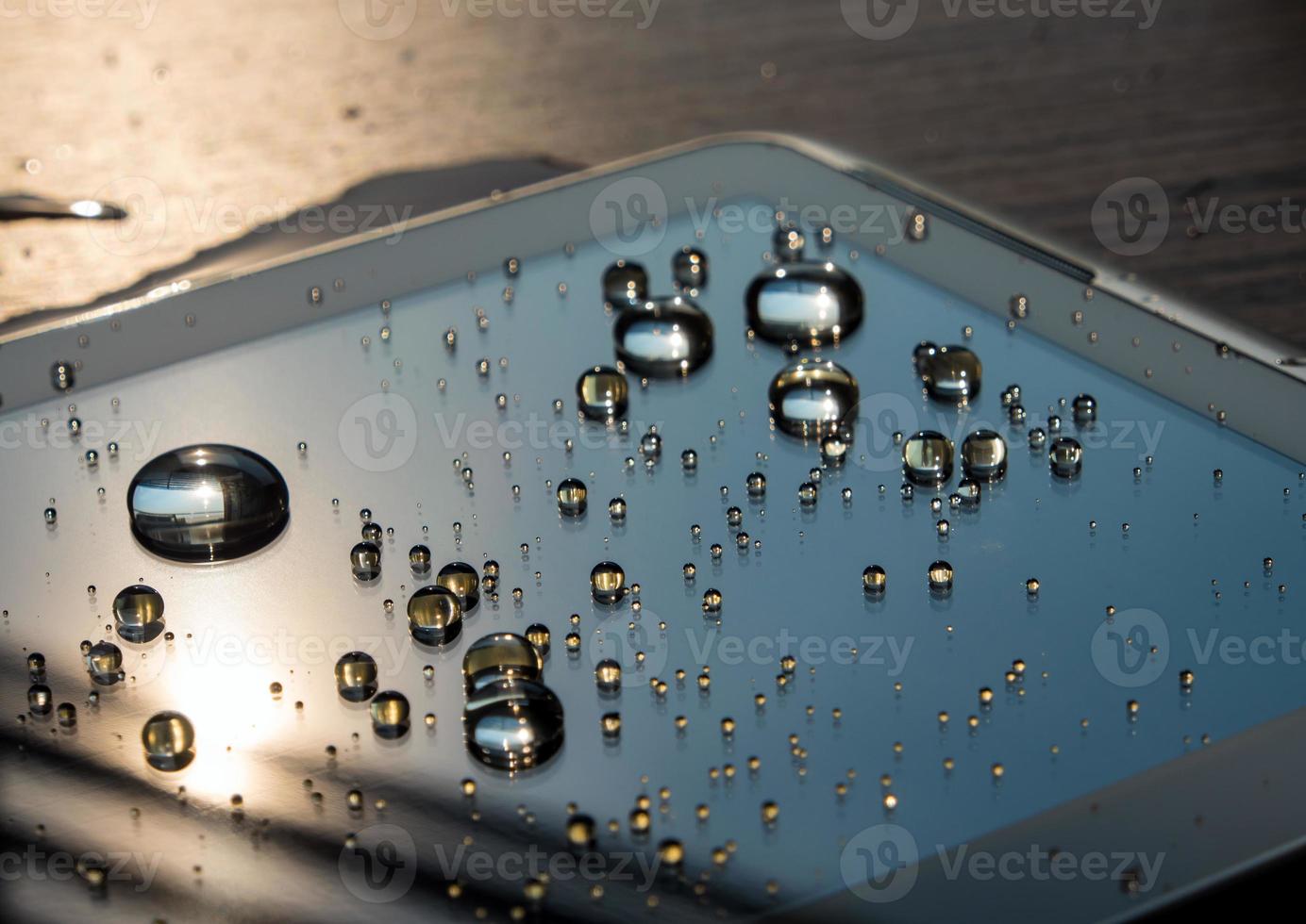 Water spilled onto the tablet, Drops of water on tablet screen photo