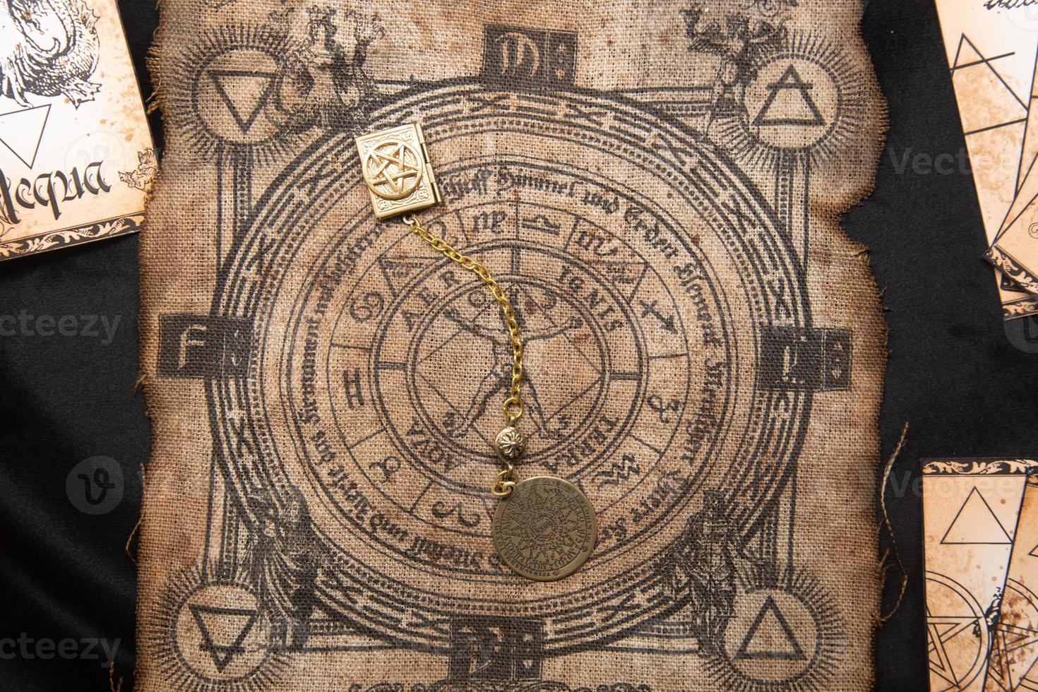 Ancient esoteric witchcraft background. Occultims and paganism old symbol, with mysterious runes alphabet photo