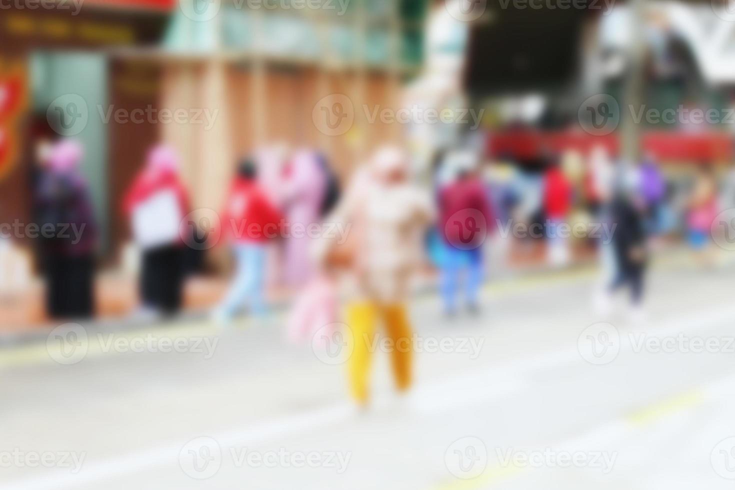 People at motion blur. Group of people walking open space. Defocused image photo