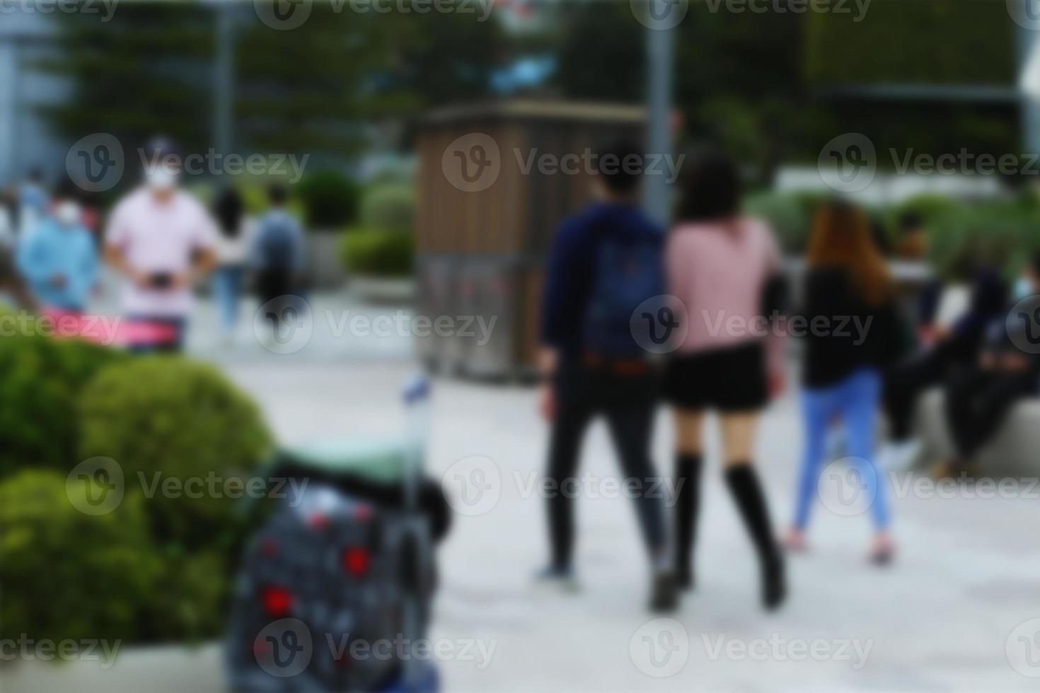 People at motion blur. Group of people walking open space. Defocused image photo