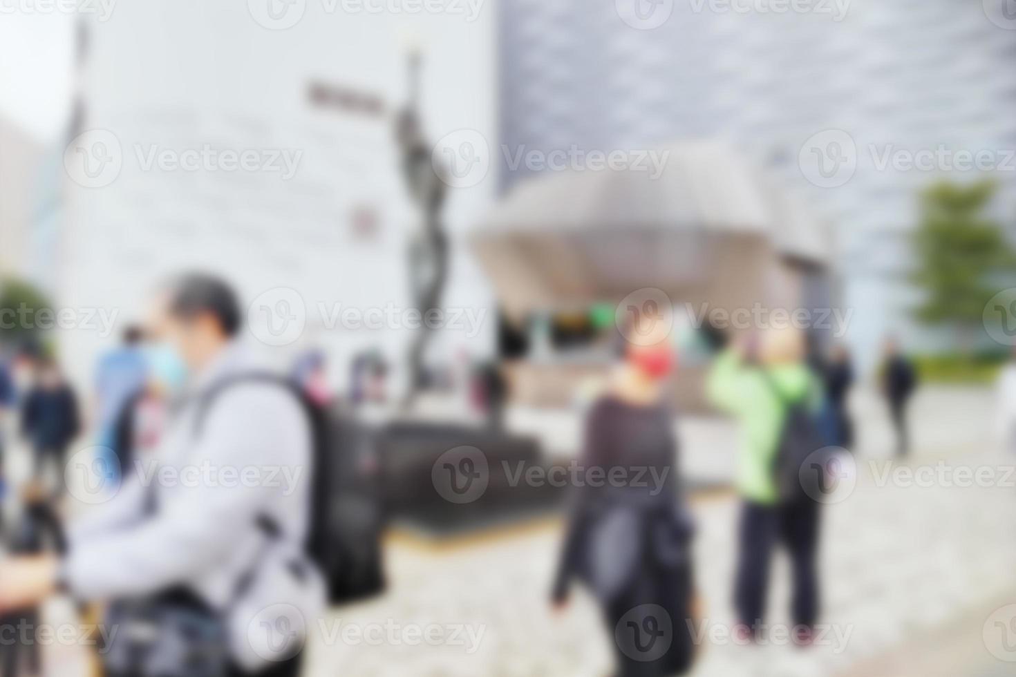 People at motion blur. Group of people walking open space. Defocused image photo