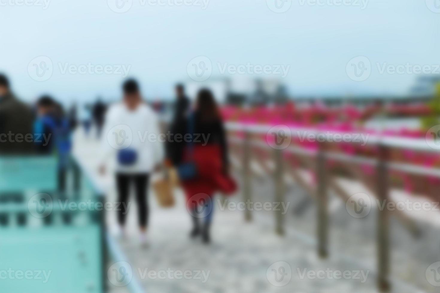 People at motion blur. Group of people walking open space. Defocused image photo