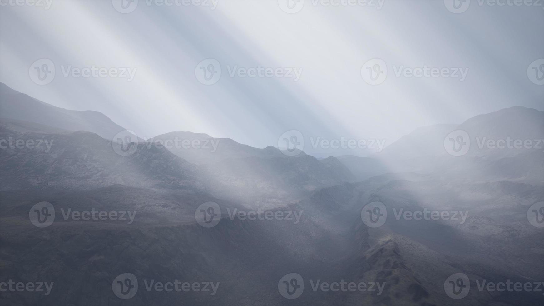 Sun Rays against the Backdrop of the Mountains photo