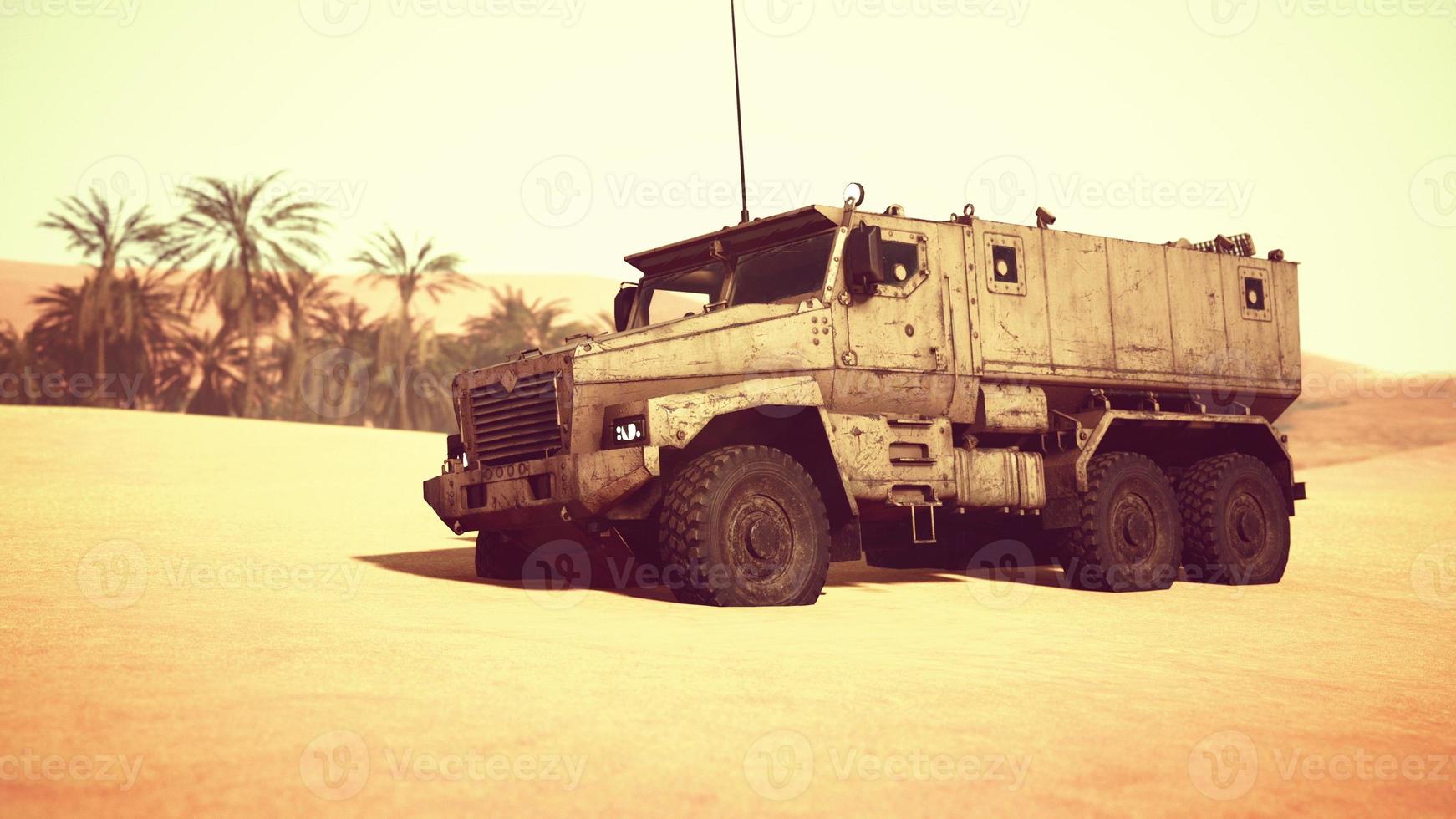 Armoured military truck in desert photo