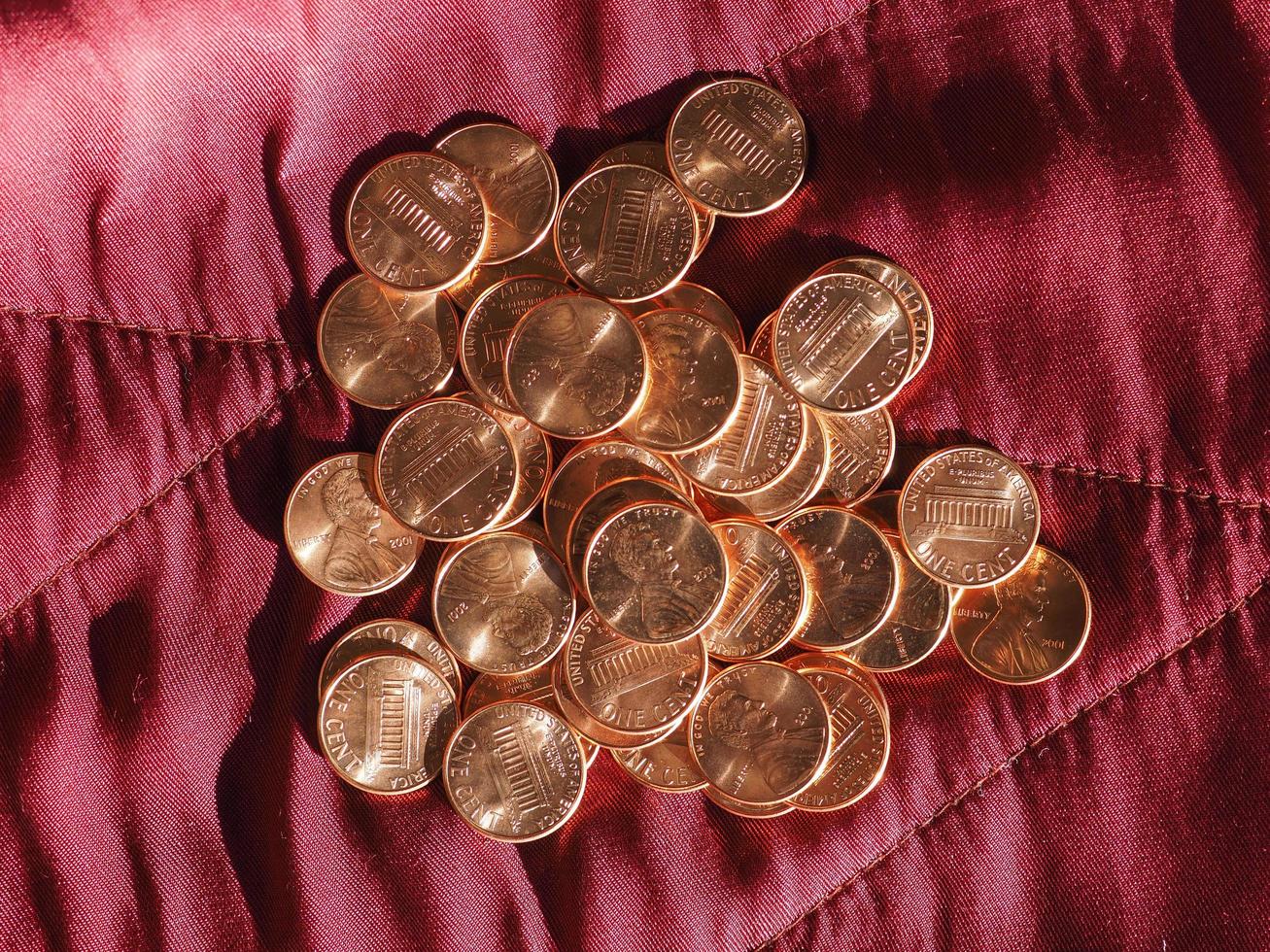 One Cent Dollar coins, United States over red velvet photo