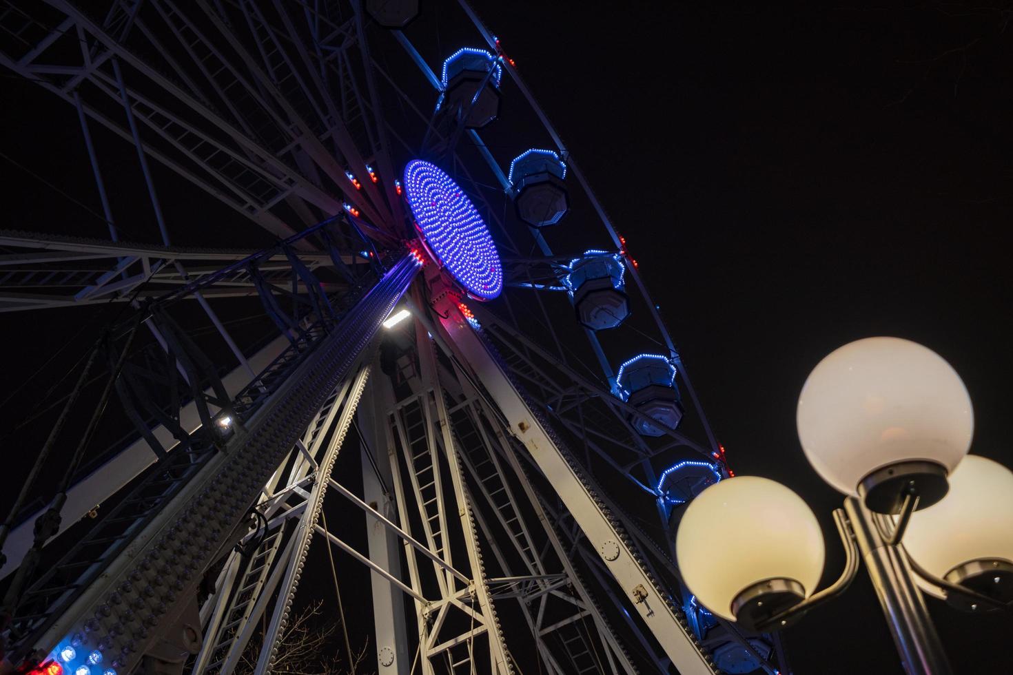 Ferris wheel beautifully illuminated at night in Leeds by the City Town Hall. photo