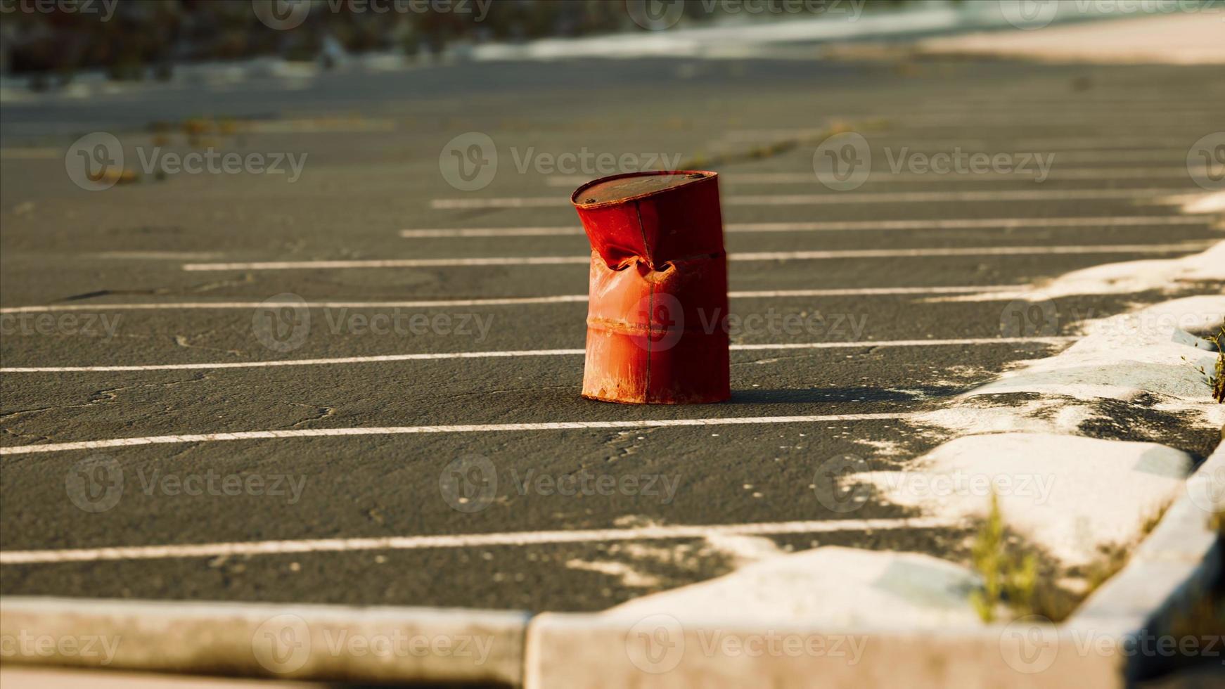 old and rusty metal barrel on parking photo