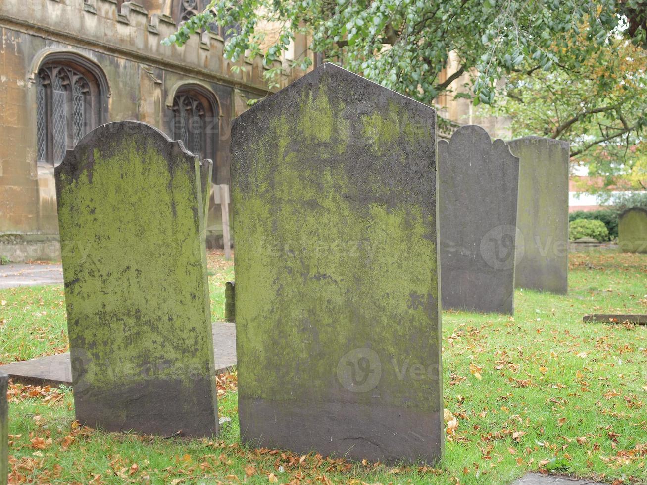 Tomb stones in ancient churchyard photo