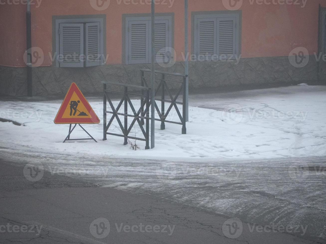 road works sign in the snow photo