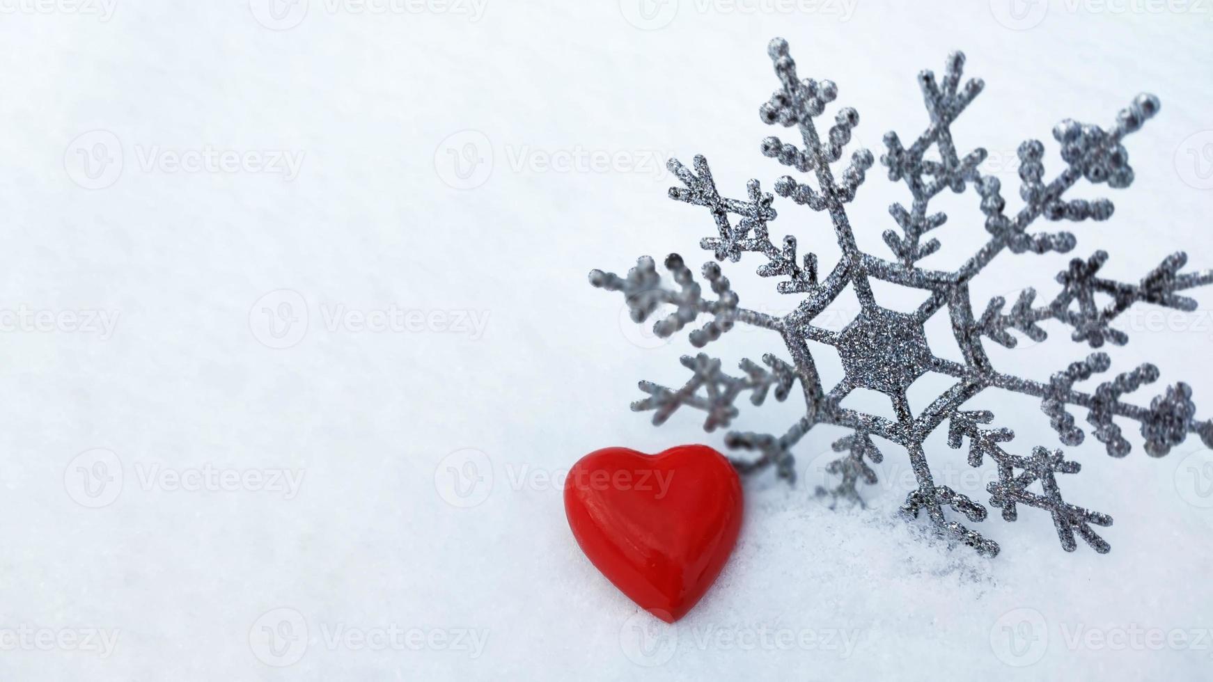 Heart and snowflake. Declaration of love. Postcard romance. Heart in the snow. photo