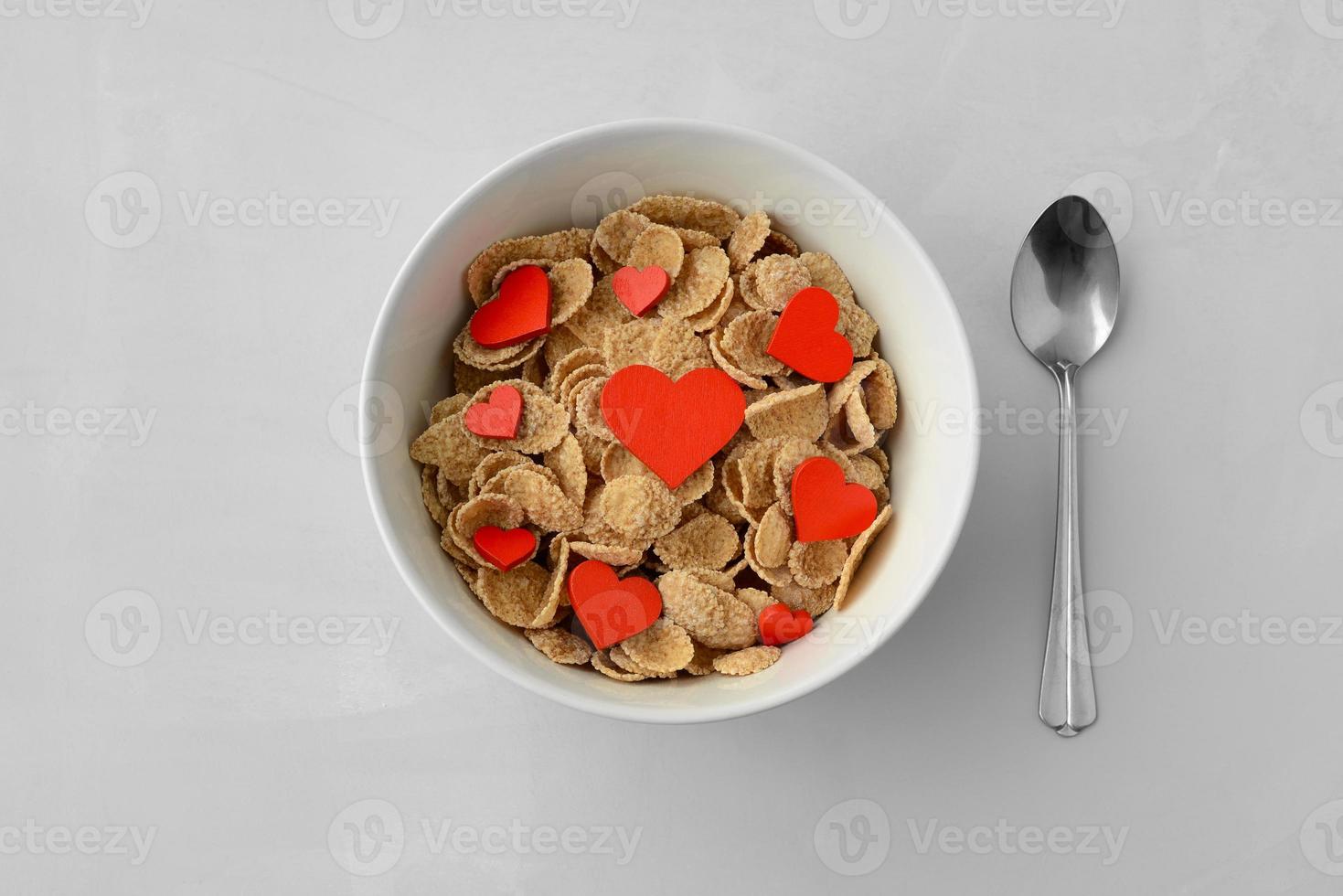 Plate with breakfast cereal and red hearts top view. Healthy breakfast, concept. Valentines Day card photo