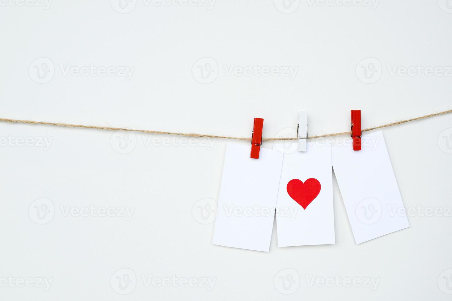 I love you Clothes pegs, paper notes hang on rope, space for text. Red Heart card. Valentines day photo