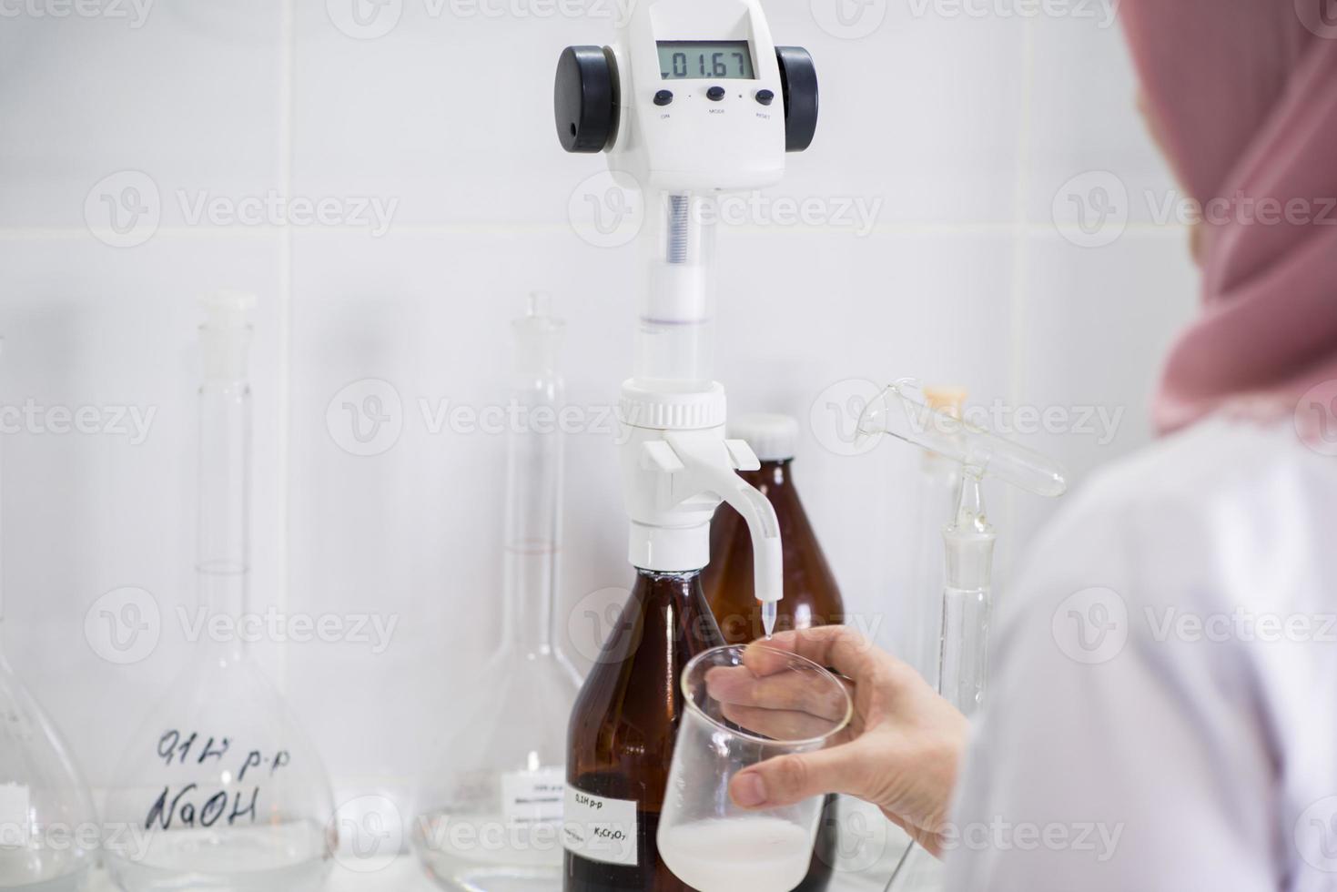 woman testing samples of dairy products in the laboratory. test laboratory of a milk factory photo