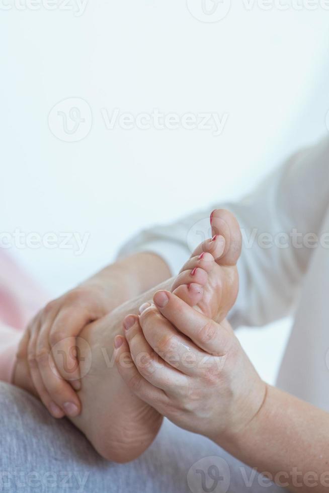 Hands making thai feet massage. Alternative medicine and thai massage concept photo