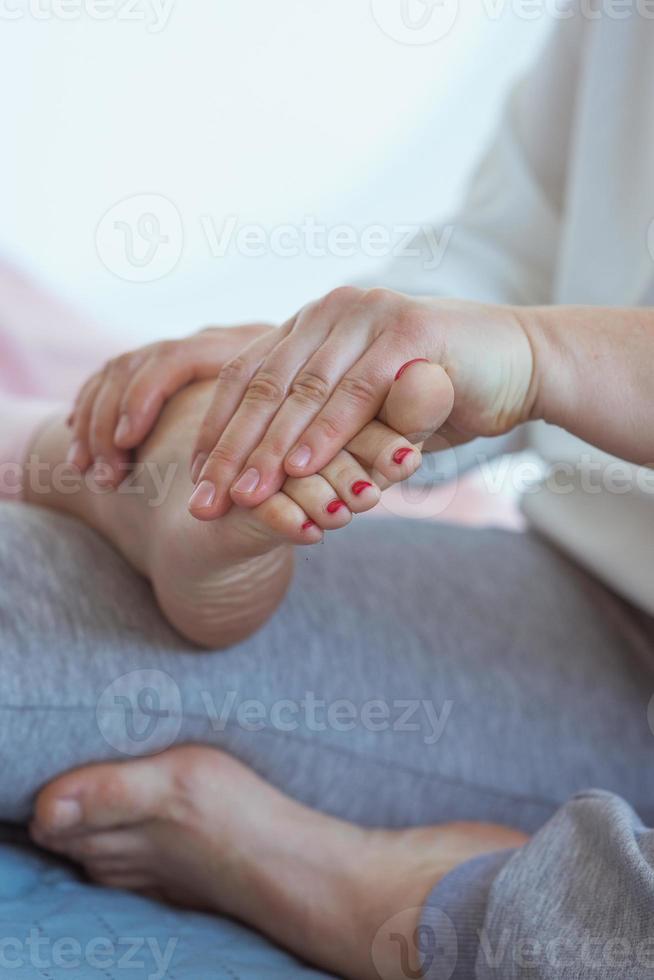 Hands making thai feet massage. Alternative medicine and thai massage concept photo