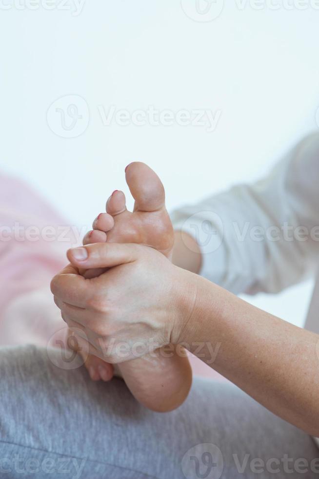 Hands making thai feet massage. Alternative medicine and thai massage concept photo