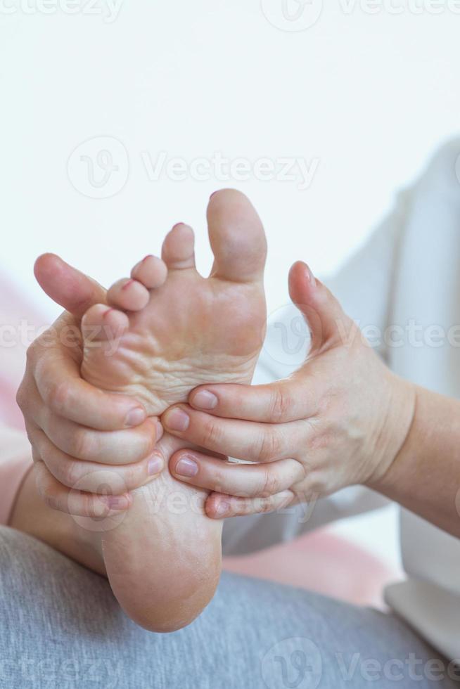 Hands making thai feet massage. Alternative medicine and thai massage concept photo