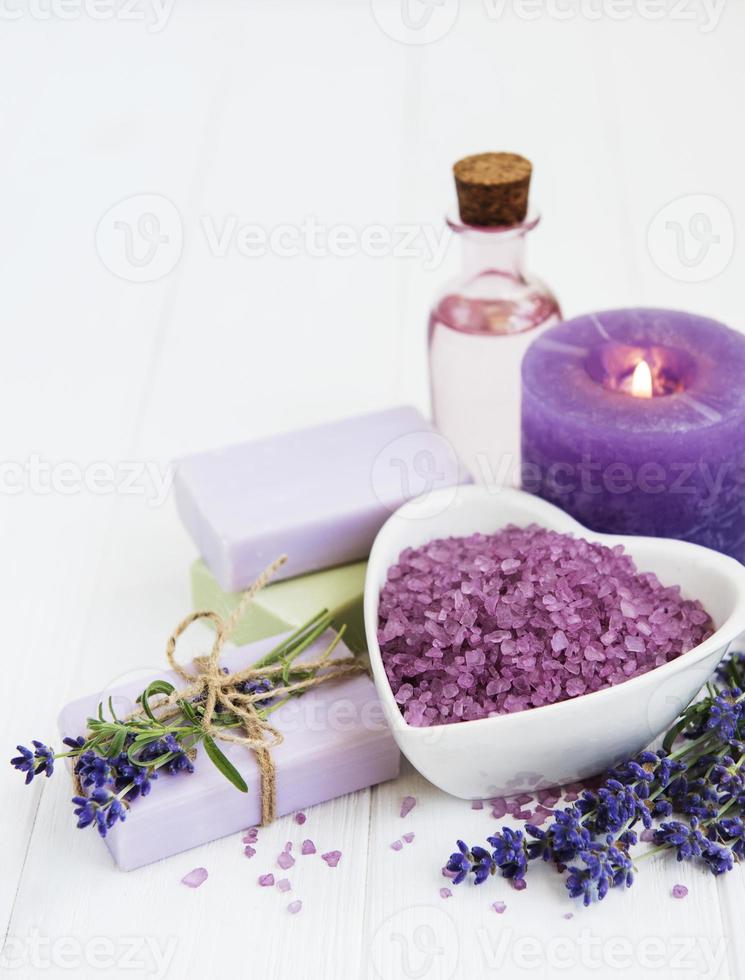 Heart-shaped bowl with sea salt, soap and fresh lavender flowers photo