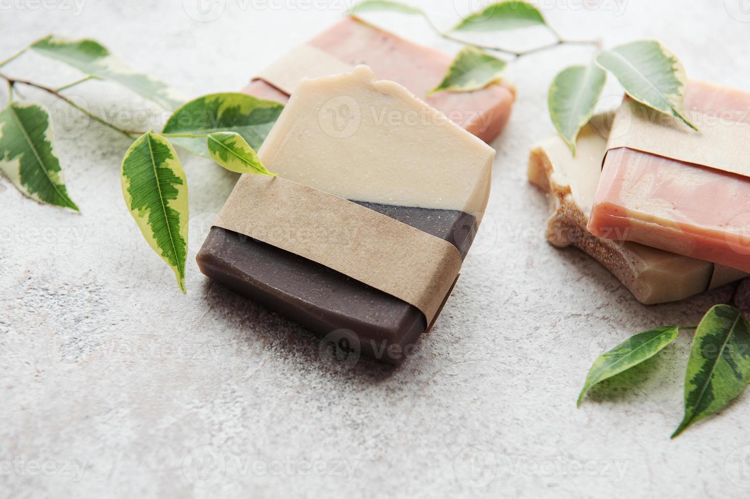 Handmade soap bars and green leaves photo