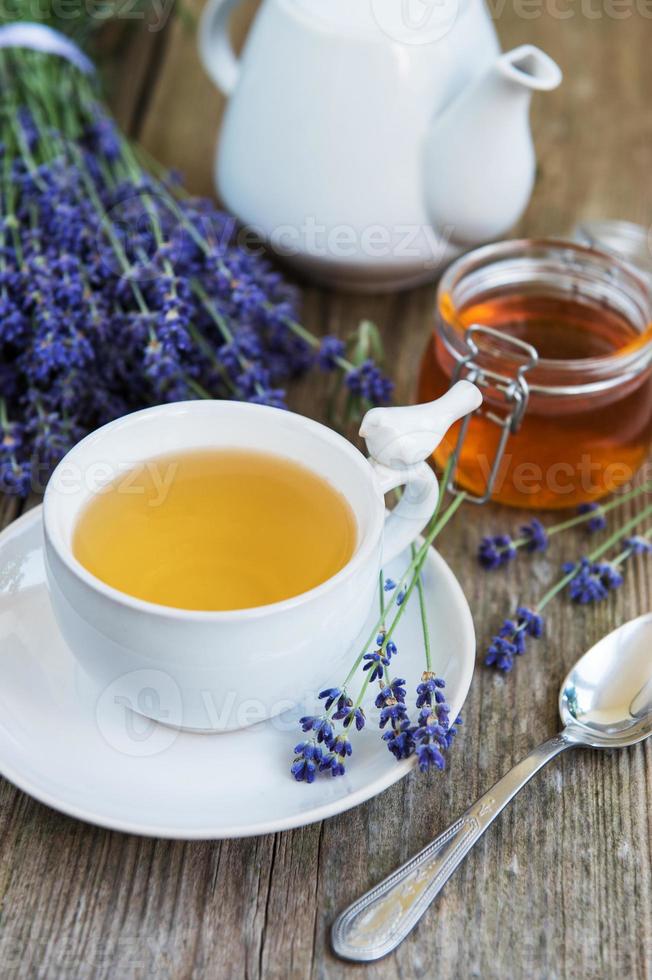 Cup of tea and honey with lavender flowers photo