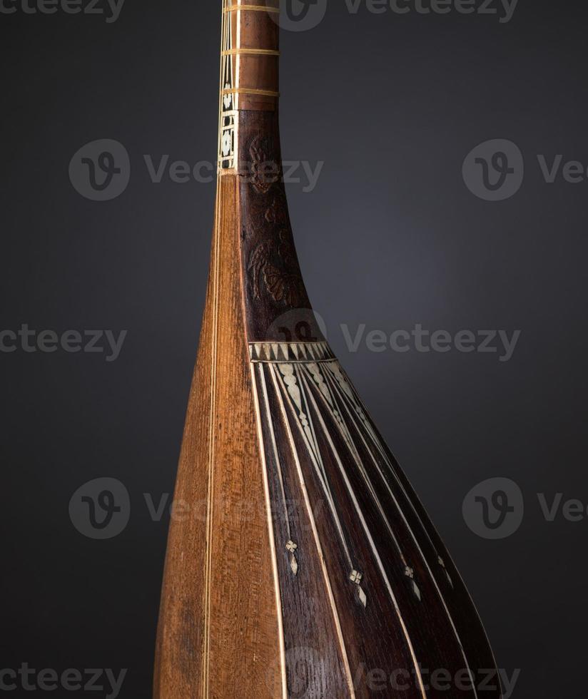 part ancient Asian stringed musical instrument on black background with backlight photo