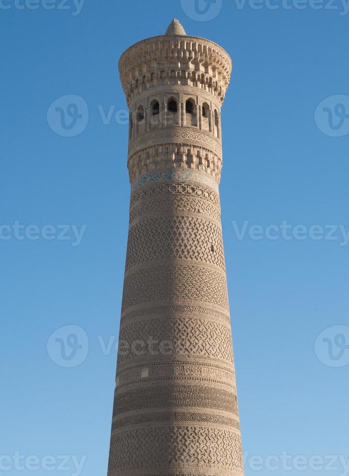 High oval tower of bricks, ancient Asian buildings. the details of the architecture of medieval Central Asia photo