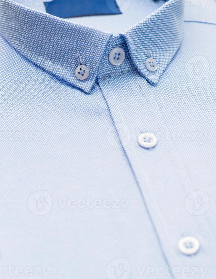 cotton shirt with a focus on the collar and button, closeup photo