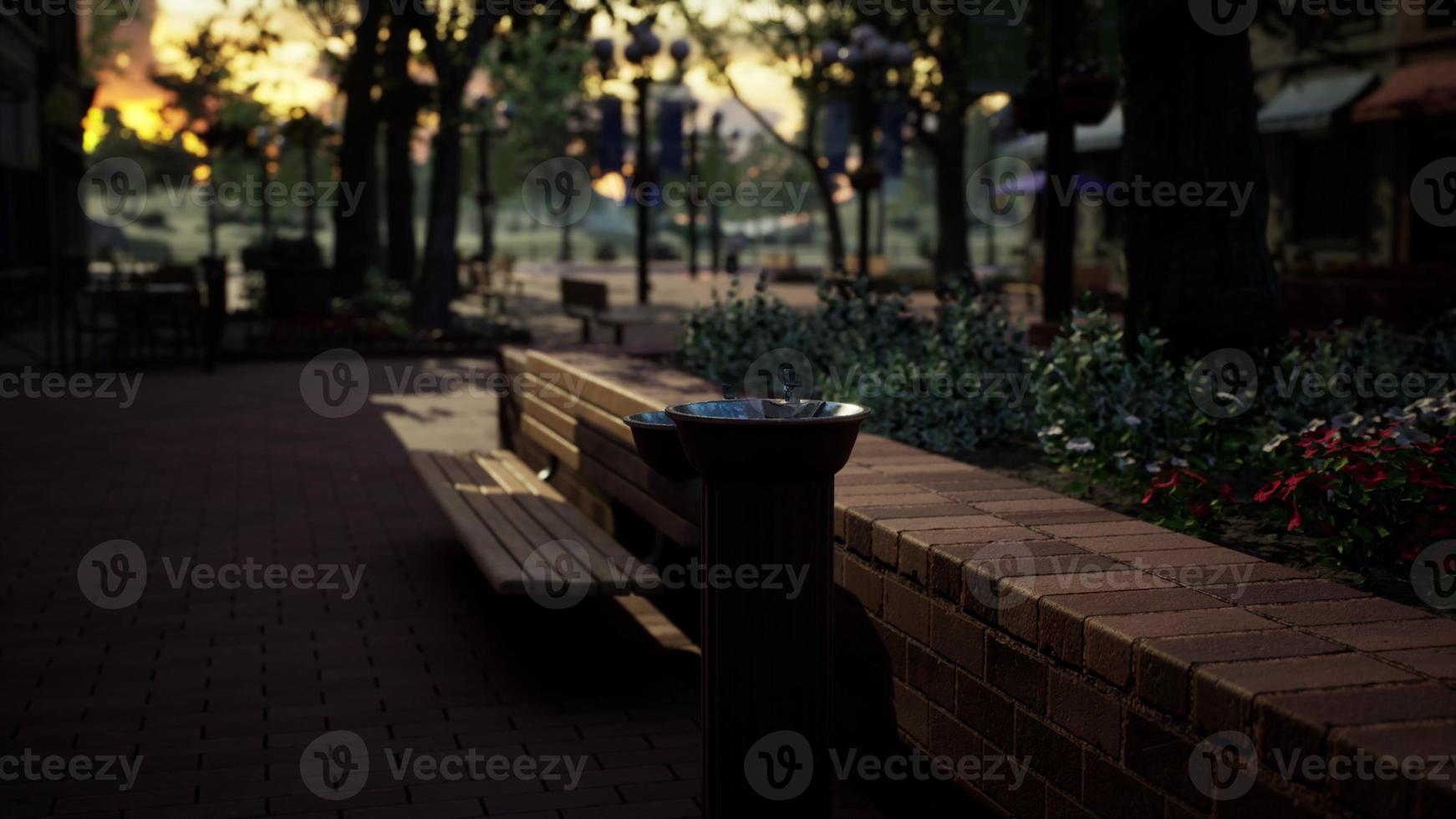 closeup of a drinking water fountain in a park on sunset photo