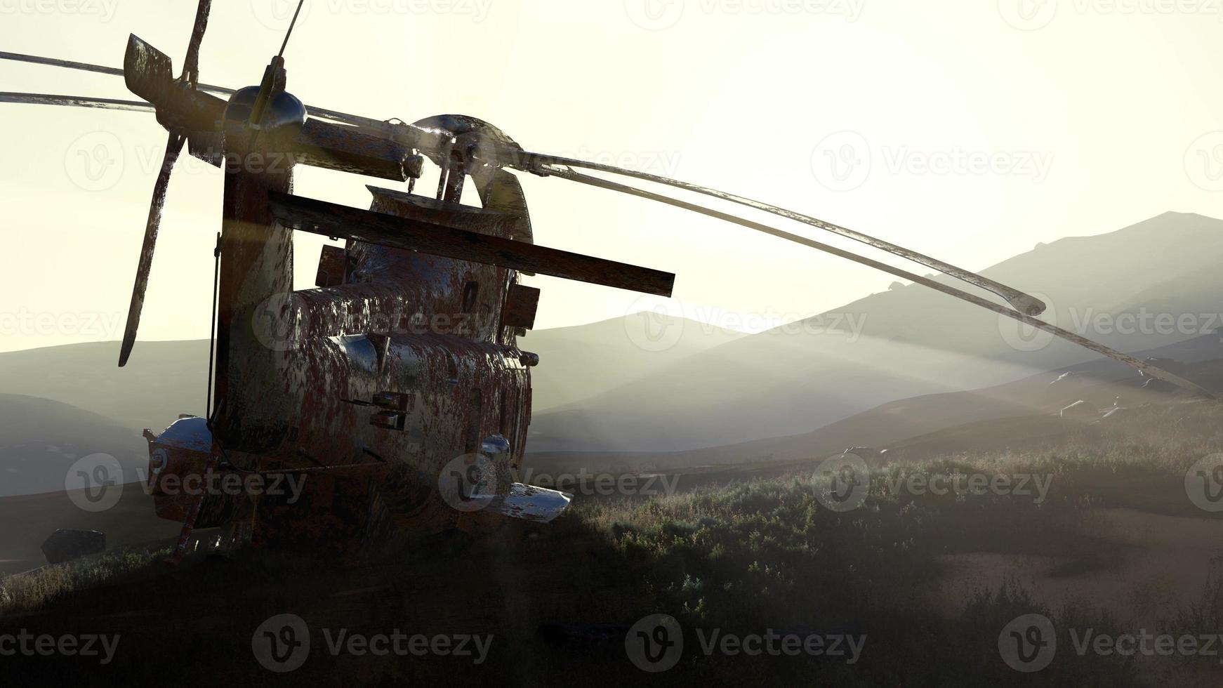 old rusted military helicopter in the desert at sunset photo
