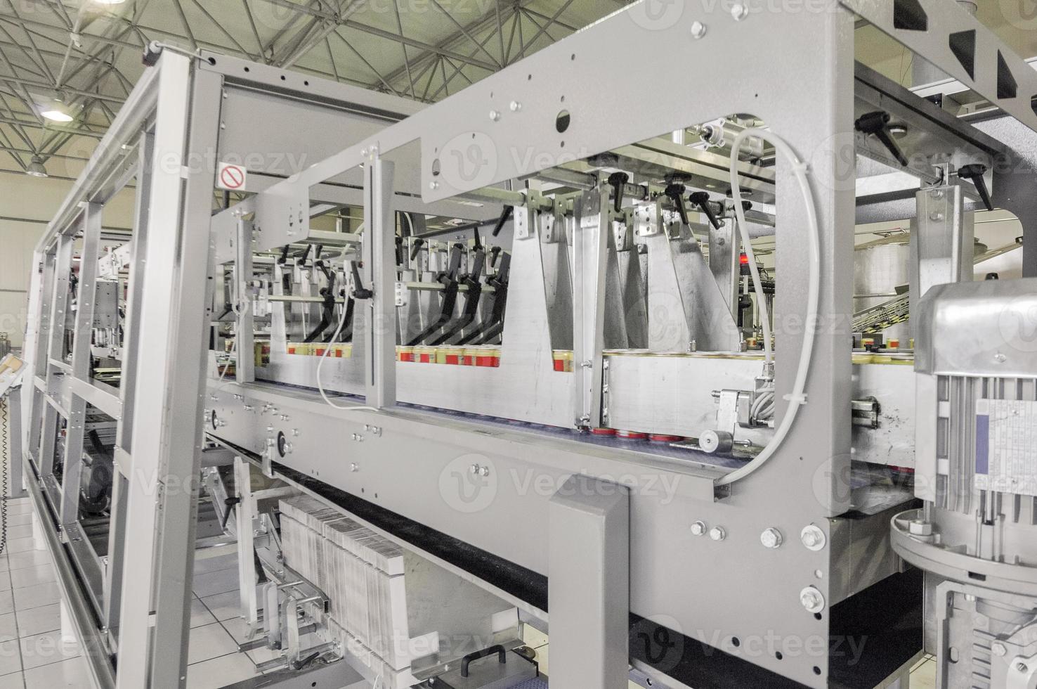 conveyor belt in motion at production and bottling of drinks in tin cans. production and bottling of drinks in tin cans photo