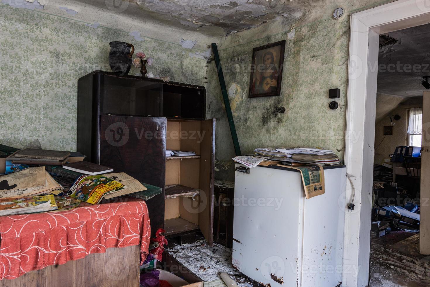 refrigerator and a wooden cabinet with picture in a room from a house photo