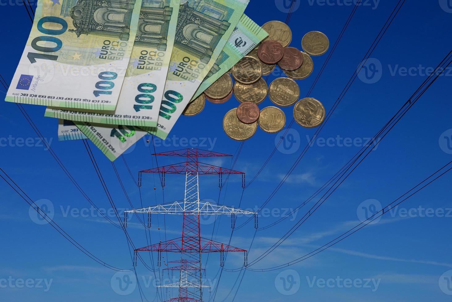 poste eléctrico rojo y blanco con muchos billetes y monedas en euros aumento del precio de la electricidad foto